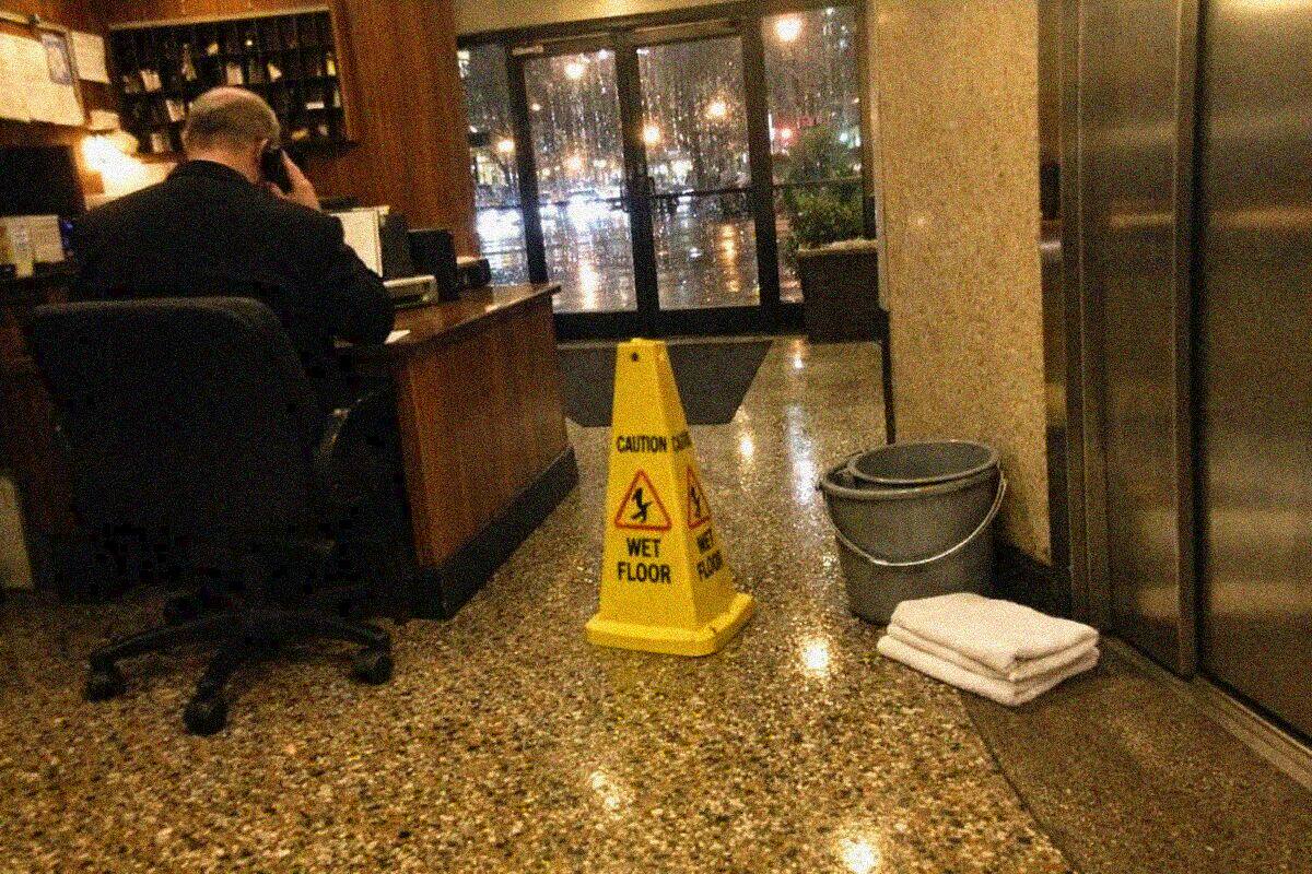 The lobby desk of a Manhattan co-op apartment building where a superintendent signs visitors in